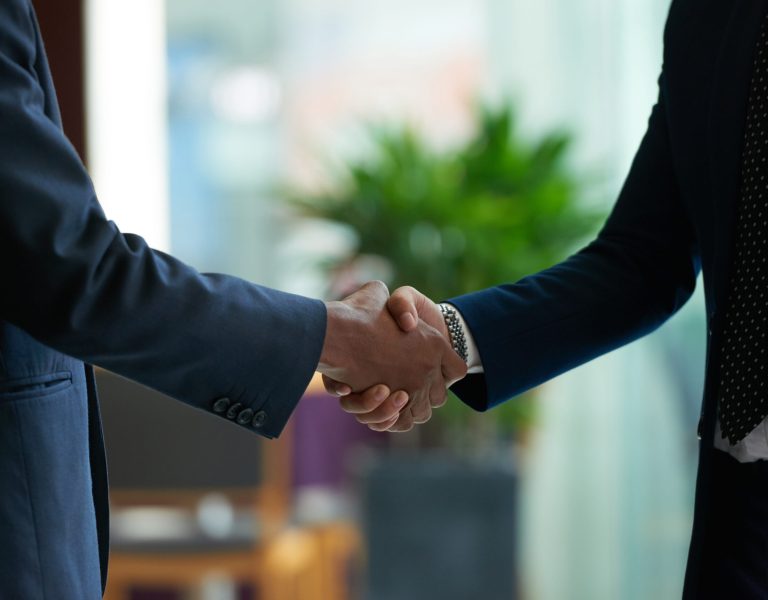 Business people shaking hands to confirm deal